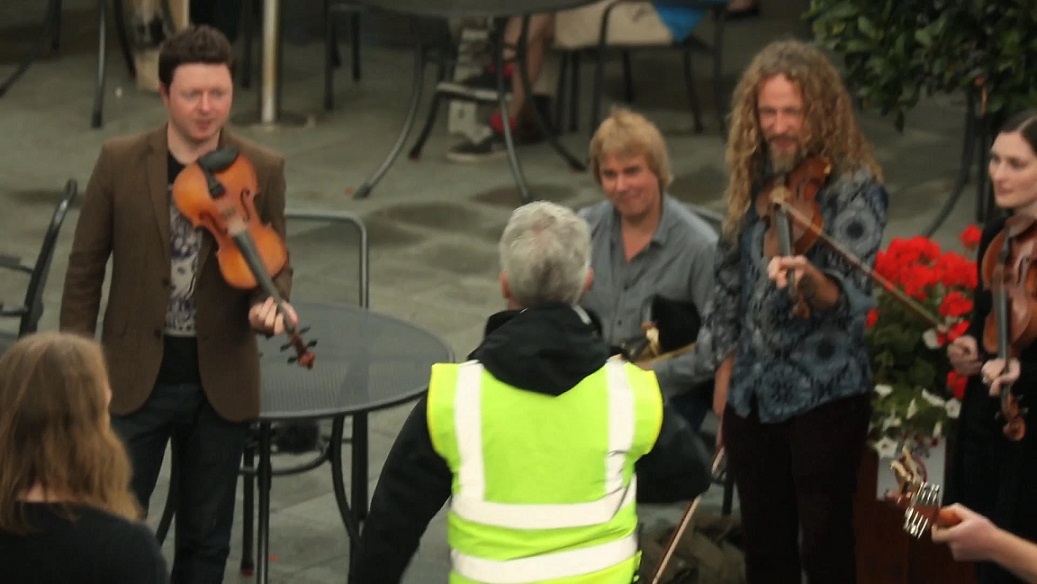 What happens when a security guard stops an Irish music flashmob