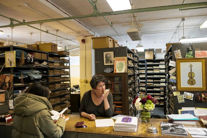 Owner Heidi Rogers helps customers at her store Frank Music in New York, on March 2, 2015. The store will be closing on Friday. PHOTO: KEITH BEDFORD FOR THE WALL STREET JOURNAL