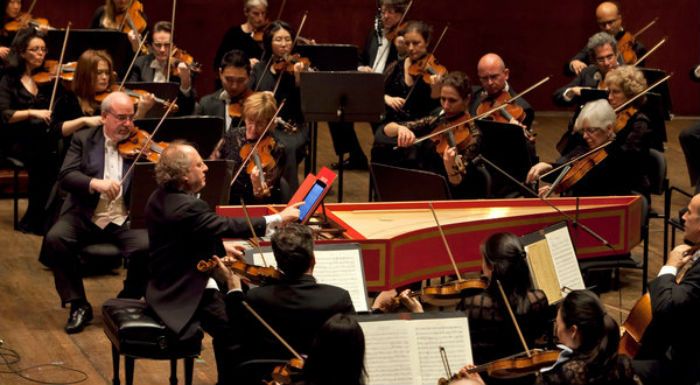 The conductor Jeffrey Kahane led the orchestra from the harpsichord, reading from an iPad, at Avery Fisher Hall. Photo: Richard Termine for The New York Times