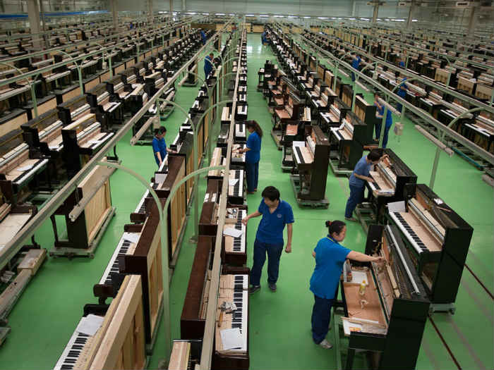 In China, one factory makes a piano a minute to keep up with demand created by 40 million children studying to play. Photo: Jeremy Sutton-Hibbert/The Guardian