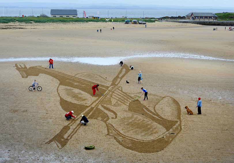 giant stradivarius on beach sand