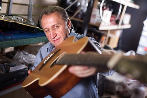 Man repairing guitar