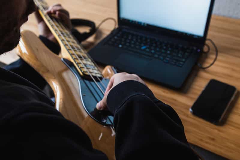 Man is learning how to play the guitar