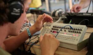 Man using music synthesizer system