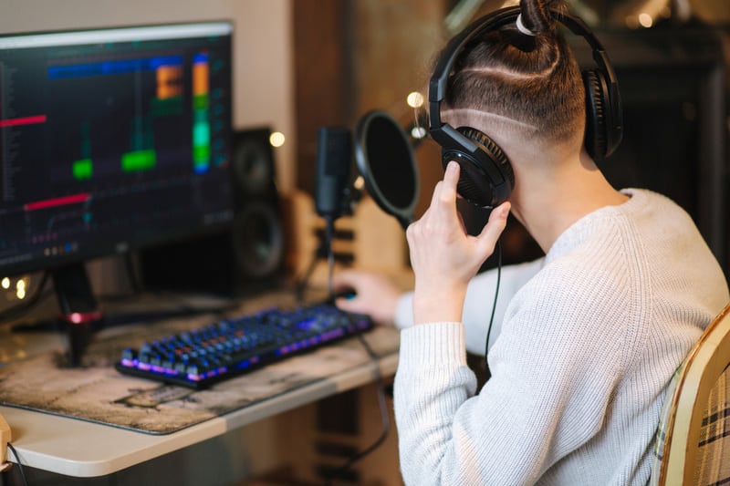 Young man in headphones makes a podcast audio recording at home