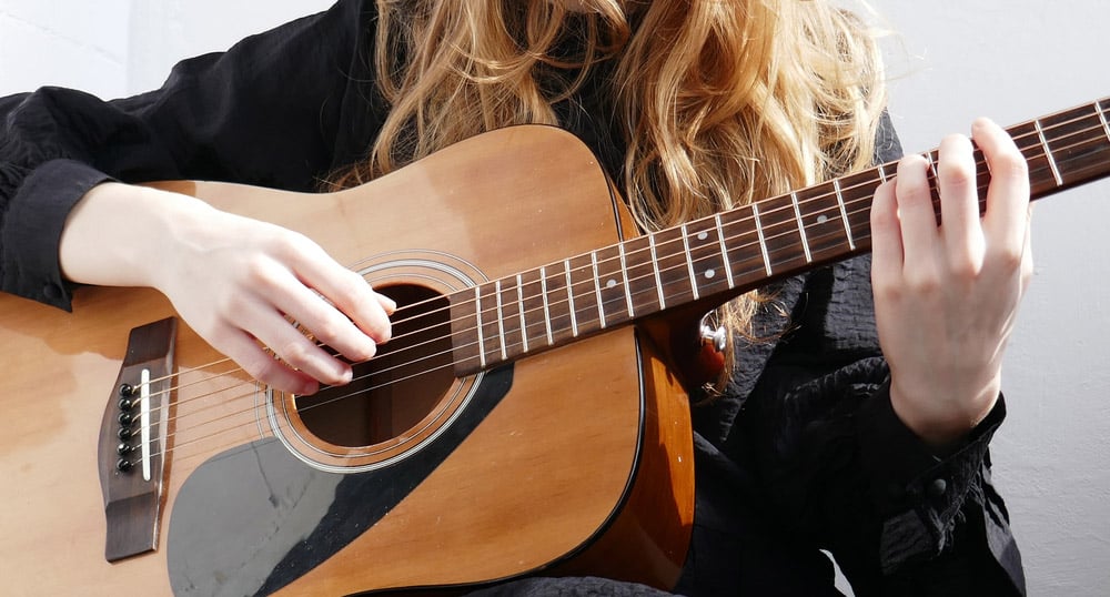 Beautiful girl plays the acoustic guitar