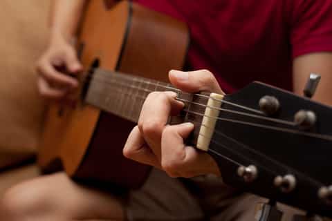 playing folk guitar
