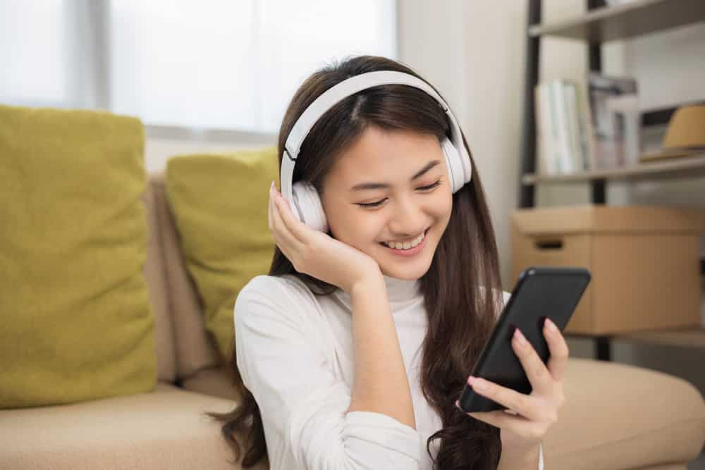 woman choose music from smartphone