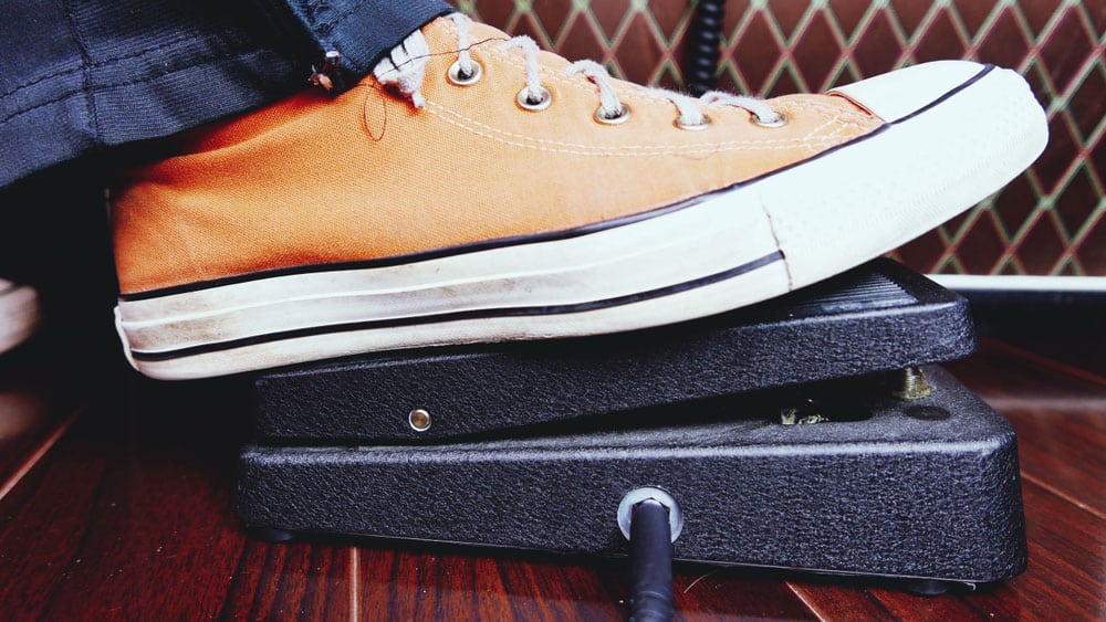 A wah-wah guitar effect pedal being operated by foot