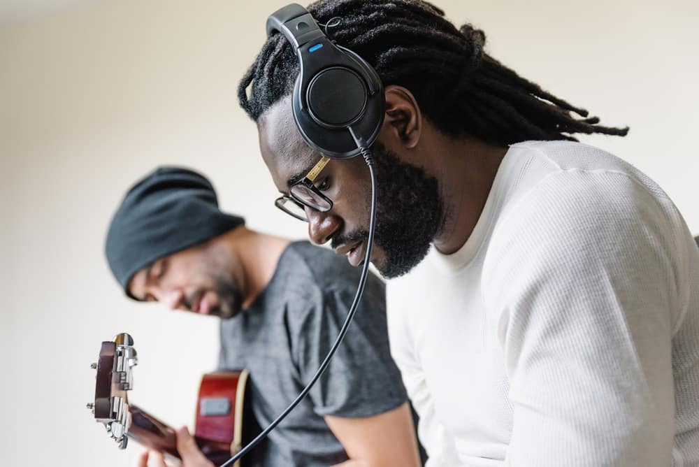 Artists producing music in their home sound studio