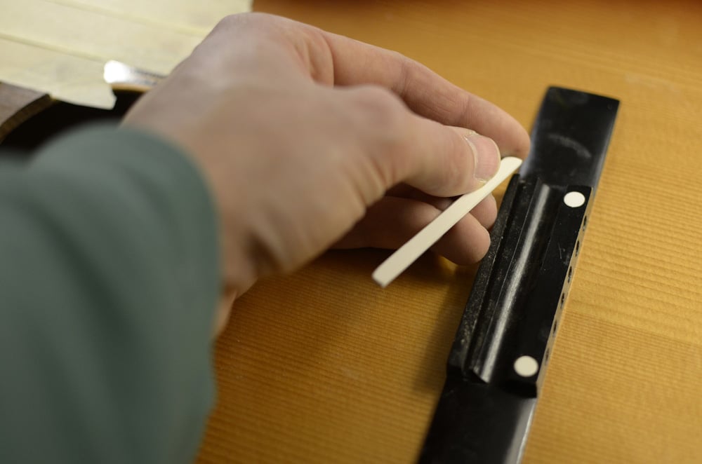 Classical guitar bridge saddle replacement and adjustment