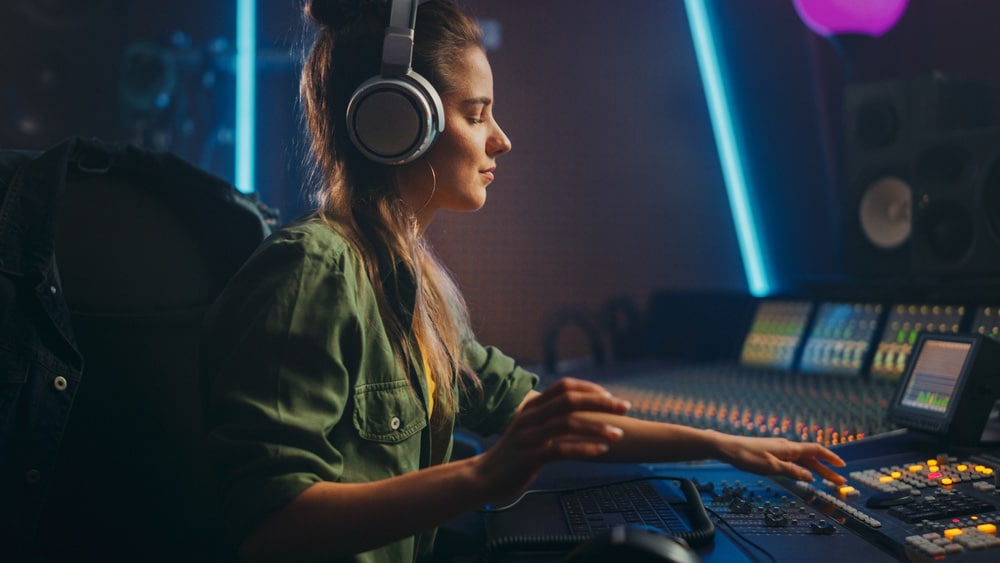 Female Artist Musician in Music Recording Studio Uses Headphones