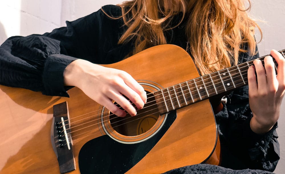 Beautiful girl plays the acoustic guitar