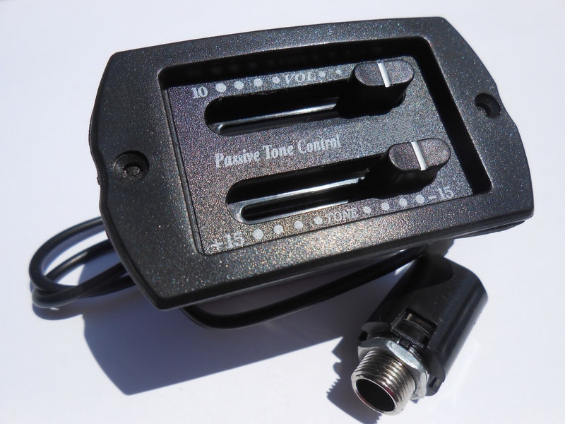 Closeup of guitar preamp with cable and plug