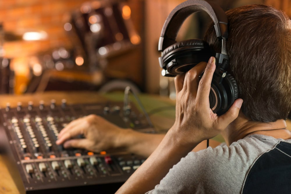 Music producer adjusting and balancing audio