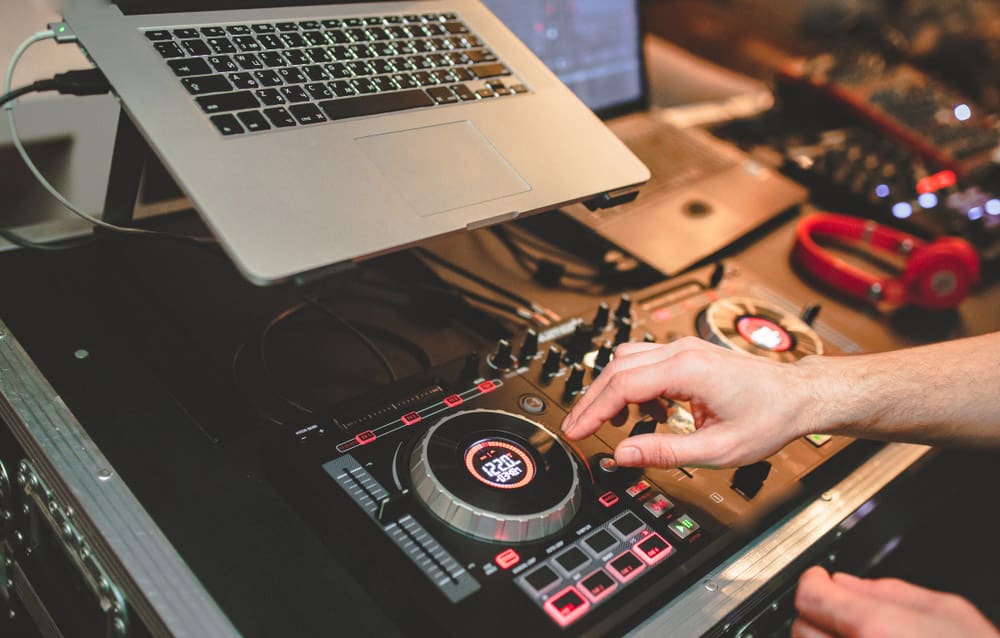 Overhead shot of Dj controlling red party dj audio equipment