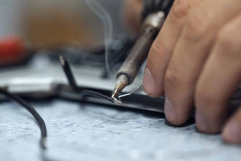 Wires being soldered together with a soldering iron