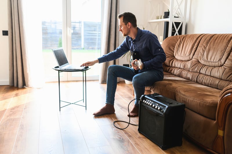 A young man is watching video tutorial