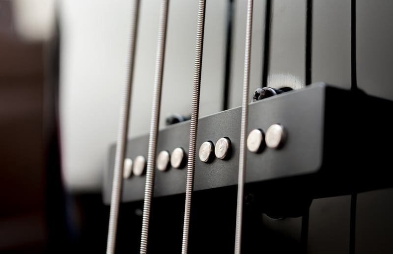 Close-up bass guitar pickups and strings