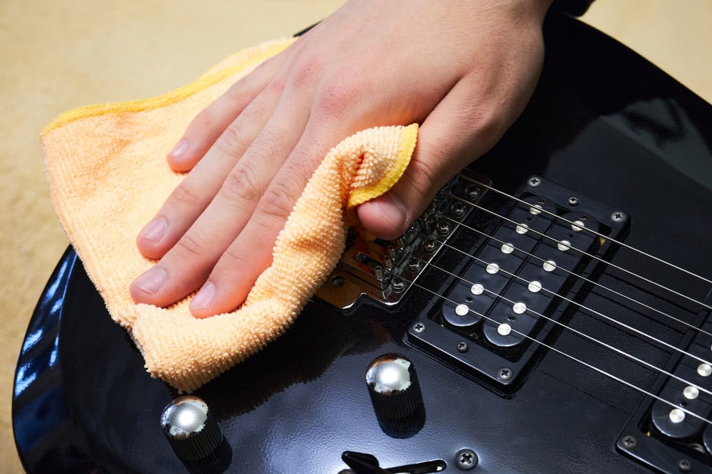 Cleaning the strings and deck of the guitar