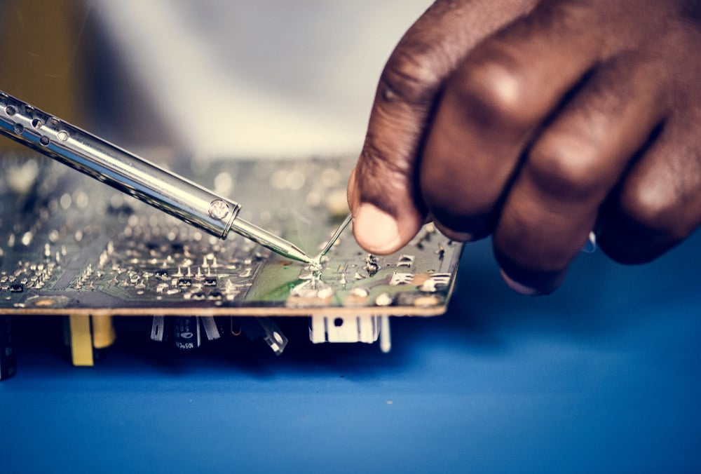 Closeup of tin soldering with electronics circuit board