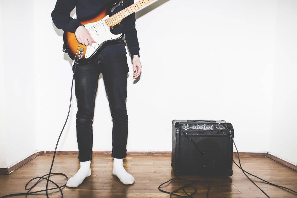 Electric Guitar Playing Teenage Kid with amplifier