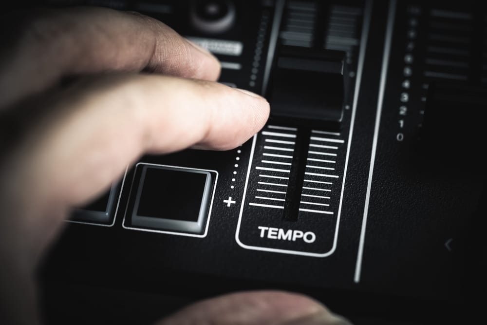 Hand controlling the Tempo BPM fader