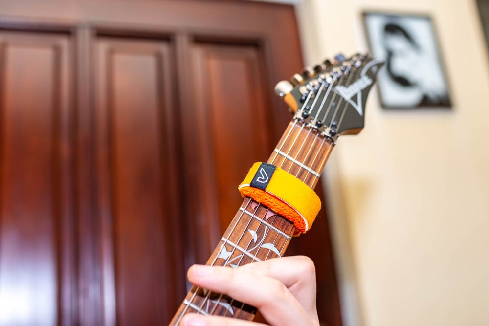 Man playing guitar using fretwrap