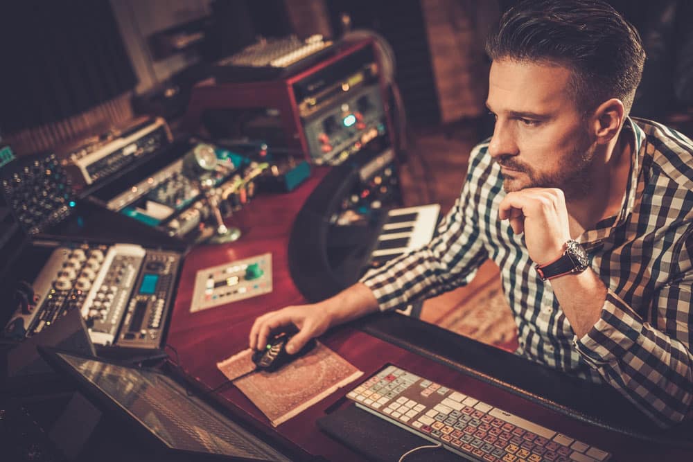 Sound engineer working at mixing panel