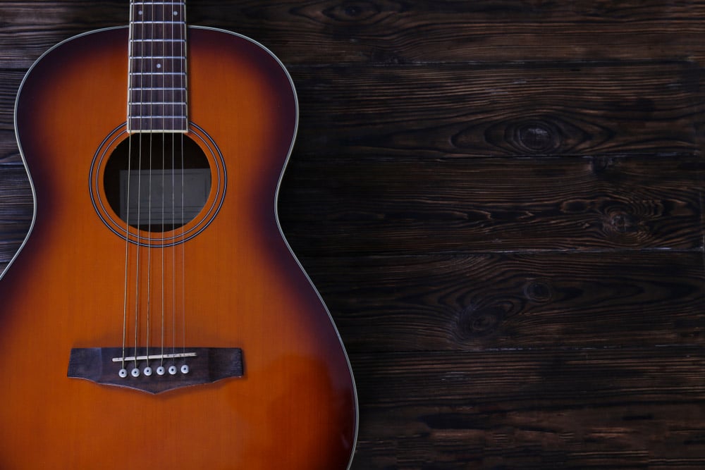 Cropped image of vintage style travel size acoustic guitar 
