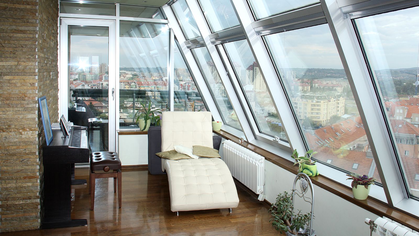 Sun room in an apartment with a piano